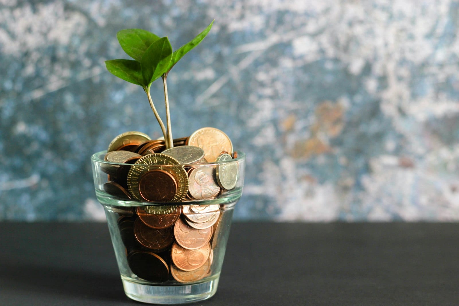 Coins and a calculator representing the 50/30/20 budgeting split