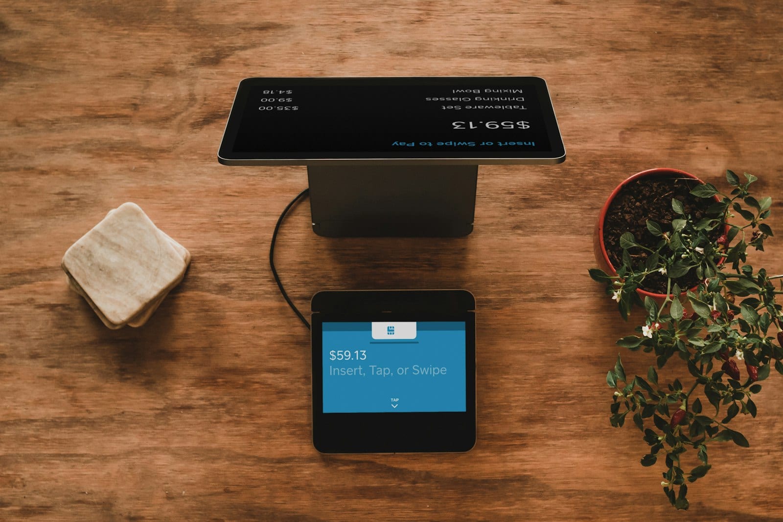 Credit card on a wooden desk next to a smartphone